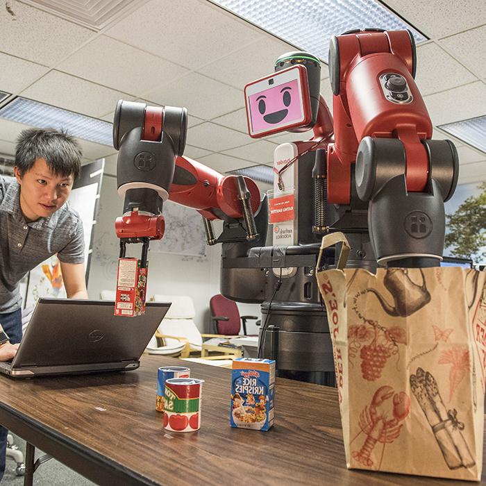 Robot operated by student bags groceries